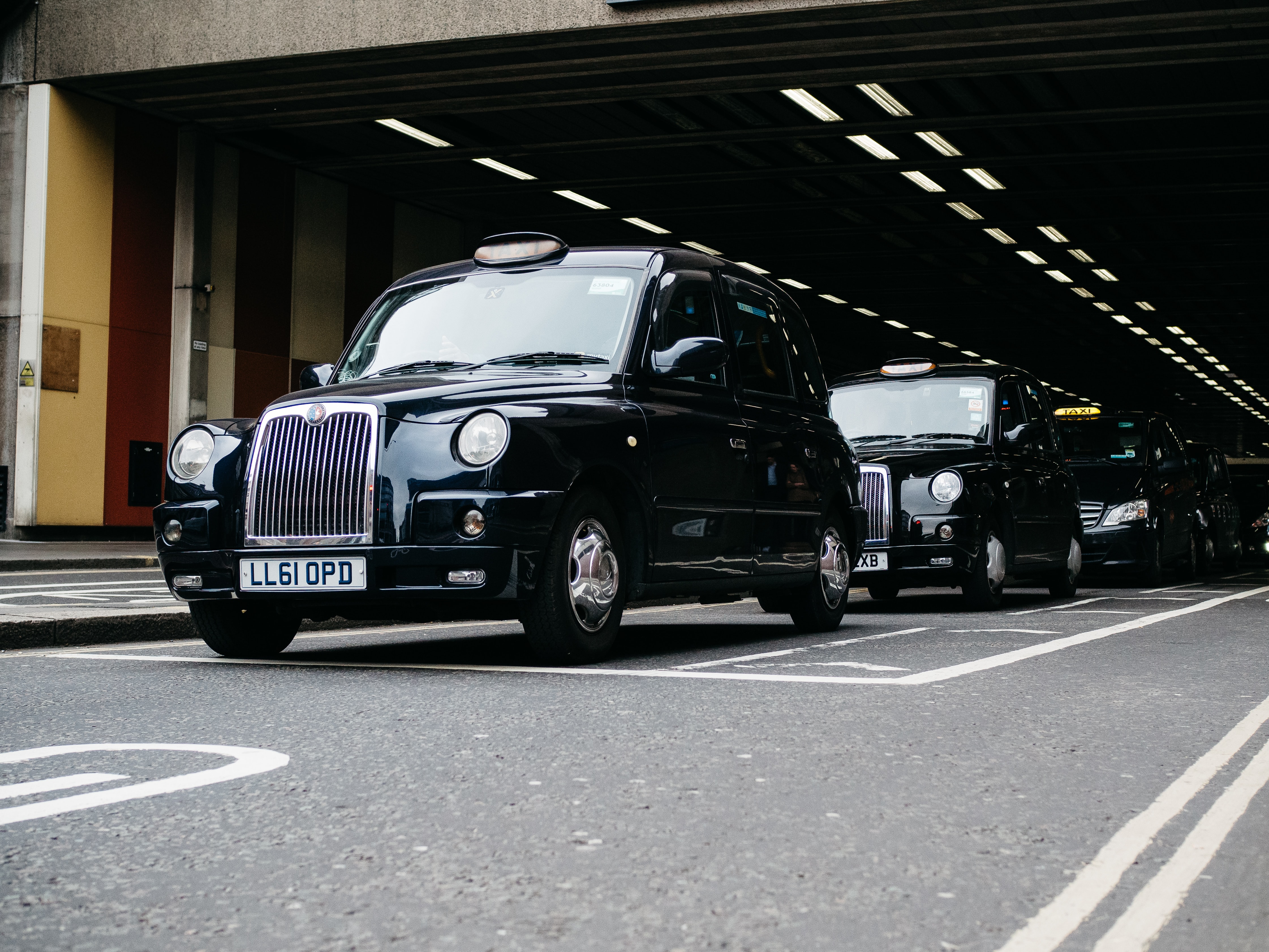 Vitale. Tradex. Hackney Taxis driving out of tunnel